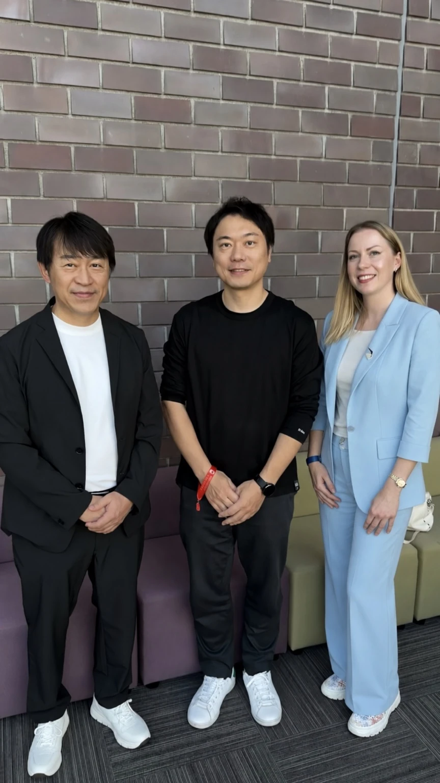 Three people photographed together during Yotsuba Japan’s visit to MIRAI TECH CITY